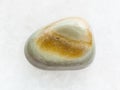 polished gray Agate gemstone on white marble