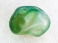 polished green dyed agate gemstone on white marble