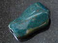 polished green Heliotrope gem stone on dark Royalty Free Stock Photo