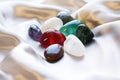 polished healing stones on a white satin sheet Royalty Free Stock Photo