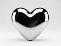 Polished heart-shaped object on a plain background Royalty Free Stock Photo