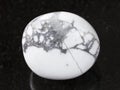 polished howlite gemstone on dark background