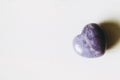 Polished lepidolite lilac stone in the shape of a heart on a white background Royalty Free Stock Photo