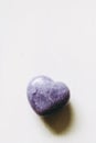 Polished lepidolite lilac stone in the shape of a heart on a white background Royalty Free Stock Photo