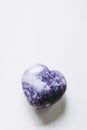 Polished lilac Lepidolite gemstone in the shape of a heart on a white background Royalty Free Stock Photo