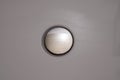 Polished metal button inset in a grey surround Royalty Free Stock Photo