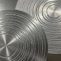 Polished metal surface featuring concentric circular patterns. The circles are Royalty Free Stock Photo