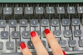polished nails of Female secretary typing on the keys of an old typewriter Royalty Free Stock Photo