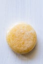 Polished orange calcite or chalcedony gemstone on a white background