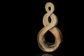 polished, painted gold loop abstract sculpture in black Royalty Free Stock Photo