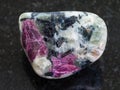 polished pink Corundum crystals in rock on dark Royalty Free Stock Photo