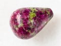 polished pink and green zoisite gemstone on white