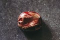 Polished red banded jasper gemstone on a black background