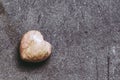 Rhodochrosite stone heart on black background