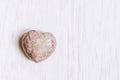 Rhodochrosite stone heart on white background