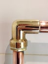 A polished right angle copper pipe fitting