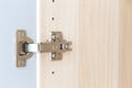 Polished Stainless door hinge on a cabinet door for interior design Royalty Free Stock Photo
