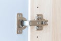 Polished Stainless door hinge on a cabinet door for interior design Royalty Free Stock Photo