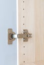 Polished Stainless door hinge on a cabinet door for interior design Royalty Free Stock Photo