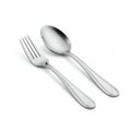 A polished, stainless steel fork and spoon set against a plain white background. The Royalty Free Stock Photo