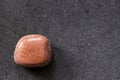 Polished sunstone gemstone on a black background