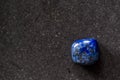 Polished tumbled lapis lazuli stone on a black background Royalty Free Stock Photo
