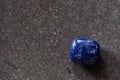 Polished tumbled lapis lazuli stone on a black background Royalty Free Stock Photo