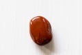 Polished tumbled stone red jasper on a white background