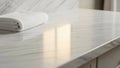 Polished white marble countertop with light gray veining, reflecting a soft light source. A neatly Royalty Free Stock Photo