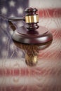 Polished Wooden Gavel Resting on Flag Reflecting Table