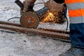 Worker polishing a tram rail