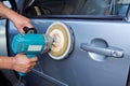 Polishing the car with power buffer machine Royalty Free Stock Photo