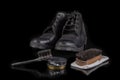 Polishing and cleaning leather shoes with a brush. Cleaning work shoes. Royalty Free Stock Photo