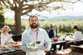 Bearded waiter welcoming on terrace Royalty Free Stock Photo