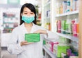 Polite chinese pharmacist posing in pharmacy