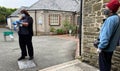 Polite patients waiting in line outside the doctors during the social distancing, mask wearing Covid 19 / CoronaVirus pandemic in