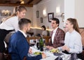 Waitress bringing dishes to guests