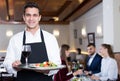 Polite waiter holding tray Royalty Free Stock Photo