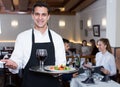 Polite waiter holding tray Royalty Free Stock Photo