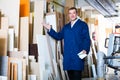 Polite workman standing with plywood pieces Royalty Free Stock Photo