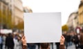 A political activist protesting holding a blank placard sign banner at a protest