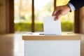 A political choice: A hand places a vote in the ballot box