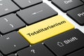 Political concept: Totalitarianism on computer keyboard background