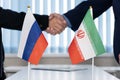 Political flags of russia and iran on table in international negotiation room. concept of negotiations, collaboration and