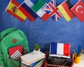 Political, news and education concept - red typewriter, flag of France and other countries, backpack, books, stationery