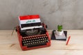 Political, news and education concept - red vintage typewriter, flag of the Iraq, pencil