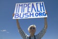 Political rally with a sign reading Impeach Bush