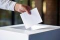 A political statement: A hand inserts a ballot into the box