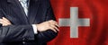 Politician crossed arms of on Swiss flag background