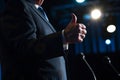 politician giving a thumbsup to the audience before speaking